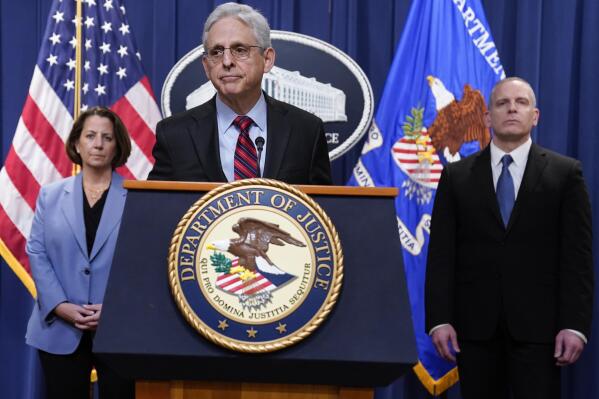 Attorney General Merrick Garland speaks at the Department of Justice in Washington, Thursday, April 13, 2023. FBI Deputy Director Paul Abbate, right, and Deputy Attorney General Lisa Monaco, left, listen. (AP Photo/Evan Vucci)