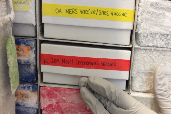 In this undated frame from video provided by the National Institute of Allergy and Infectious Diseases (NIAID), a scientist returns a novel coronavirus vaccine sample to a freezer in Bethesda, Md. The flu-like virus that exploded from China has researchers worldwide once again scrambling to find a vaccine against a surprise health threat, with no guarantee one will arrive in time. (NIAID via AP)