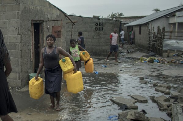 
              People return to Praia Nova Village, one of the most affected neighbourhoods following a cyclone in the coastal city of Beira, Mozambique, Sunday March 17, 2019. Families are returning to the vulnerable shanty town following cyclone high winds and rain.  More than 1,000 people are feared dead in Mozambique four days after a cyclone slammed into the southern African country. (Josh Estey/CARE via AP)
            