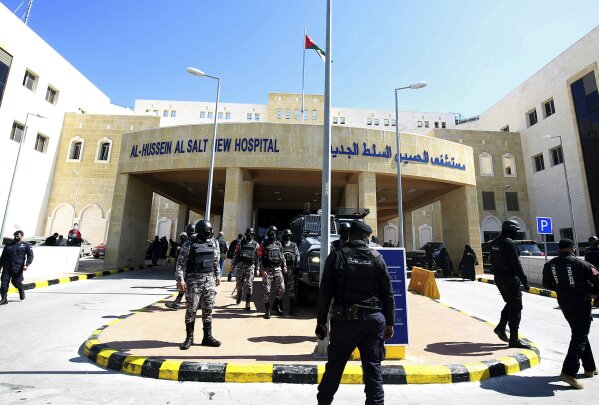Soldiers stand guard outside Al-Hussein Al Salt Hospital in Salt, Jordan on Saturday, March 13, 2021.  State media reports that Jordan’s Health Minister, Nathir Obeidat, has stepped down after at least six patients in a COVID-19 ward at the hospital near the capital Amman died due to a shortage of oxygen supplies. (AP Photo/Raad Adayleh)