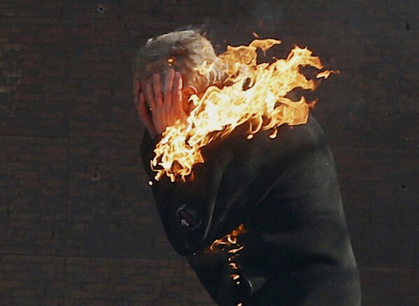 FILE - In this file photo taken on Feb. 18, 2014, an anti-government protester is engulfed in flames during clashes with riot police outside Ukraine's parliament in Kyiv, Ukraine. On Nov. 21, 2023, Ukraine marks the 10th anniversary of the uprising that eventually led to the ouster of the country’s Moscow-friendly president. (AP Photo/Efrem Lukatsky, file)