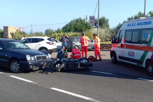 
              Ambulance personnel tend to a man lying on the ground, later identified as actor George Clooney, after being involved in a scooter accident near Olbia, on the Sardinia island, Italy, Tuesday, July 10, 2018. Actor George Clooney was taken to the hospital in Sardinia on Tuesday and released after being involved in an accident while riding his motor scooter, hospital officials said. “He is recovering at his home and will be fine,” spokesman Stan Rosenfield told The Associated Press in an email. The John Paul II hospital in Olbia confirmed Clooney had been treated and released after Tuesday’s accident. Local media that had gathered at the hospital said Clooney left in a van through a side exit. (AP Photo/Mario Chironi)
            