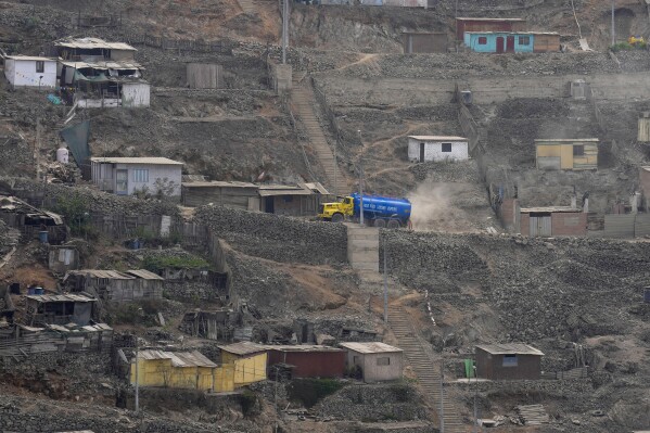 A water truck passes through Pamplona Alta area in Lima, Peru, Thursday, March 7, 2024. (AP Photo/Martin Mejia)