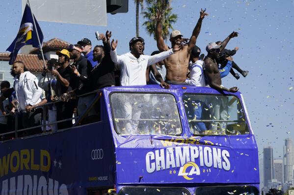 Confetti flies as Los Angeles Rams players celebrate on a bus during the team's victory parade in Los Angeles, Wednesday, Feb. 16, 2022, following their win Sunday over the Cincinnati Bengals in the NFL Super Bowl 56 football game. (AP Photo/Marcio Jose Sanchez)