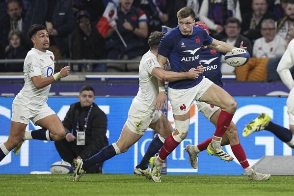 France's Leo Barre is tackled by England's George Ford during the Six Nations rugby union international match between France and England at Groupama Stadium, Lyon, France, Saturday, March 16, 2024. (AP Photo/Laurent Cipriani)