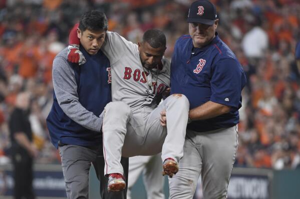 Boston Red Sox designated hitter Eduardo Nunez, center, is carried off the field after he was injured running to first base during the first inning in Game 1 of baseball's American League Division Series against the Houston Astros, Thursday, Oct. 5, 2017, in Houston. (AP Photo/Eric Christian Smith)