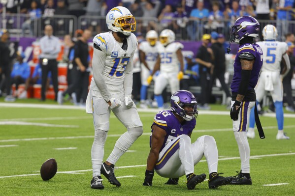 Los Angeles Chargers wide receiver Keenan Allen (13) celebrates in front of Minnesota Vikings linebacker Jordan Hicks (58) after catching a pass for a first down during the second half of an NFL football game, Sunday, Sept. 24, 2023, in Minneapolis. (AP Photo/Bruce Kluckhohn)