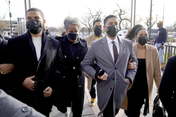 FILE - Actor Jussie Smollett, center, arrives with family Thursday, Dec. 2, 2021, at the Leighton Criminal Courthouse on day four of his trial in Chicago. Smollett is accused of lying to police when he reported he was the victim of a racist, anti-gay attack in downtown Chicago nearly three years ago. (AP Photo/Charles Rex Arbogast, File)