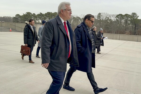 CORRECTS ATTORNEY NAME TO JOSEPH MURRAY FROM JOHN MURRAY Former U.S. Rep. George Santos, right, leaves federal court with his attorney, Joseph Murray, Tuesday, Jan. 23, 2024, in Central Islip, N.Y. Santos appeared, Tuesday, in federal court on Long Island, New York for another hearing ahead of his criminal fraud trial later this year. Unlike a prior appearance in December, Santos' lawyer John Murray spoke only briefly about the potential for a plea deal, saying negotiations remain "productive" and that both sides would report back to the judge if there were any notable developments. (AP Photo/Philip Marcelo)