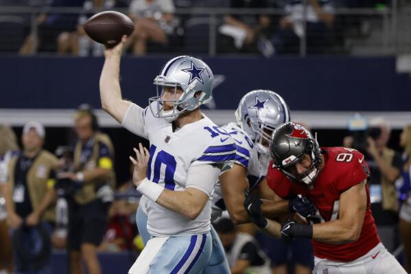 FILE - Dallas Cowboys quarterback Cooper Rush (10) throws a pass under pressure from Tampa Bay Buccaneers linebacker Carl Nassib (94) during the second half of an NFL football game in Arlington, Texas, Sept. 11, 2022. The Cowboys are looking for Rush to win the same way he did a year ago in Minnesota, starting Sunday against defending AFC champion Cincinnati after Dak Prescott fractured a bone near his right thumb in a season-opening loss to Tampa Bay. (AP Photo/Michael Ainsworth)