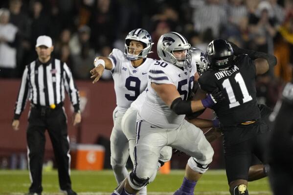 Kansas State offensive lineman Cooper Beebe (50), center, blocks Iowa State defensive lineman Tyler Onyedim (11) as Kansas State quarterback Adrian Martinez (9) passes the ball during the first half of an NCAA college football game, Saturday, Oct. 8, 2022, in Ames, Iowa. (Matthew Putney)