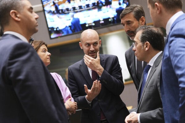 French Foreign Minister Jean-Noel Barrot, center, speaks with from left, Malta's Foreign Minister Ian Borg, Slovenia's Foreign Minister Tanja Fajon, Slovakia's Foreign Minister Juraj Blanar and Spain's Foreign Minister Jose Manuel Albares Bueno during a meeting of EU foreign ministers at the European Council building in Brussels, Monday, June 23, 2025. (AP Photo/Virginia Mayo)