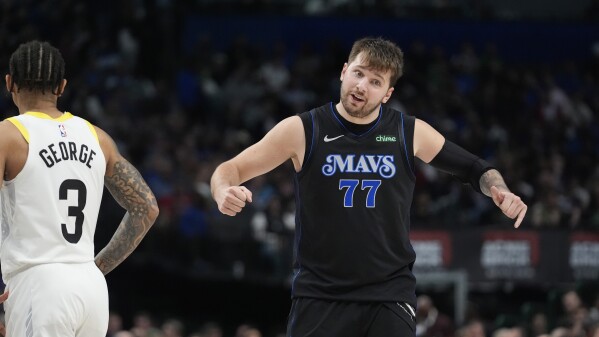 Dallas Mavericks guard Luka Doncic (77) reacts after a call as Utah Jazz guard Keyonte George (3) looks on during the second half of an NBA basketball game in Dallas, Thursday, March 21, 2024. (AP Photo/LM Otero)