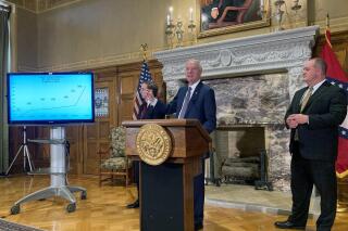 Arkansas Gov. Asa Hutchinson speaks at a news conference at the state Capitol in Little Rock, Arkansas on Thursday, April 22, 2021 with House Speaker Matthew Shepherd, left, and Senate President Jimmy Hickey, right. (AP Photo/Andrew Demillo)
