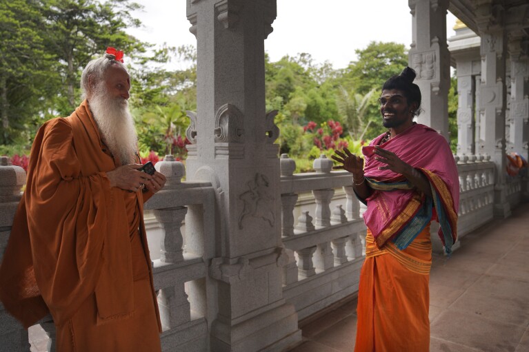 Paramacharya Sadasivanatha Palaniswami and Pravinkumar Vasudeva, right, who serves as a priest at the Iraivan Temple, at the Kauai Hindu Monastery on July 9, 2023, in Kapa'a, Hawaii. (AP Photo/Jesse Wardarski)