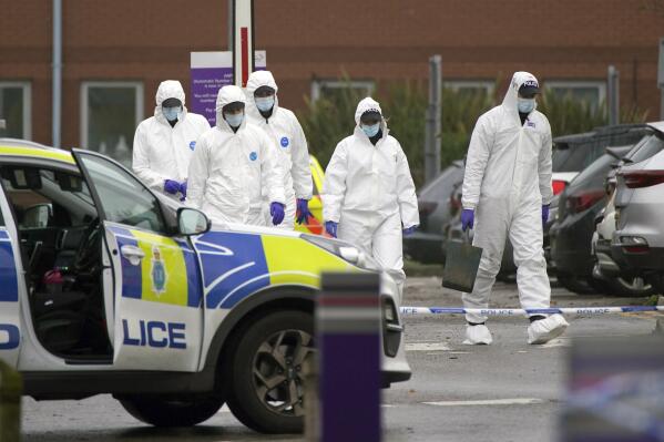 Forensic police officers walk outside Liverpool Women's Hospital after an explosion on Sunday killed one person and injured another, in Liverool, England, Tuesday, Nov. 16, 2021. British police have released four men arrested under terrorism laws by detectives investigating a homemade bomb explosion in a Liverpool taxi, as they work to understand the motives of the suspected bomber, who died in the blast. (Peter Byrne/PA via AP)