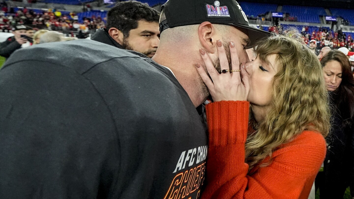 Taylor Swift greets Super Bowl entrant Travis Kelce with a kiss after the Chiefs win the AFC title