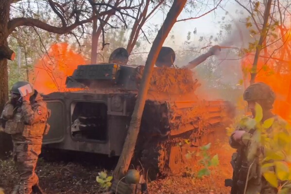 In this photo taken from a video released by Russian Defense Ministry press service on Wednesday, Oct. 30, 2024, Russian Gvozdika 120mm howitzer fires towards Ukrainian positions at border area of Kursk region, Russia. (Russian Defense Ministry Press Service via AP)