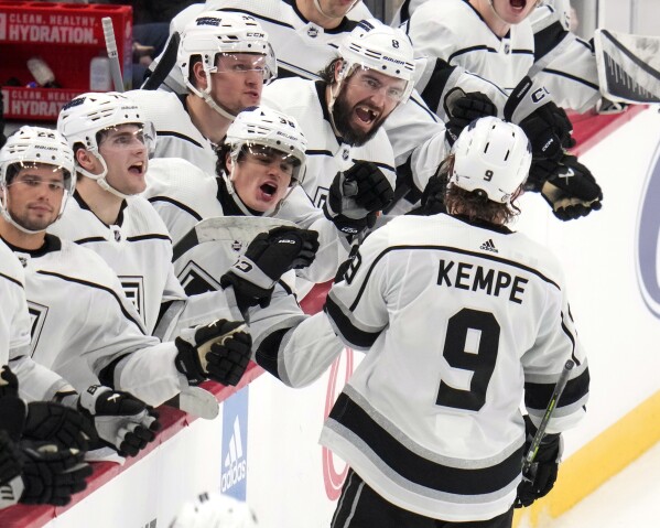 Los Angeles Kings' Adrian Kempe (9) returns to the bench after scoring his second goal of the third period during an NHL hockey game against the Pittsburgh Penguins in Pittsburgh, Sunday, Feb. 18, 2024. (AP Photo/Gene J. Puskar)