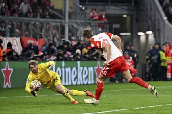 Bayern's Harry Kane scores his side's third goal during the Champions League round of 16 second leg soccer match between FC Bayern Munich and Lazio at the Allianz Arena stadium in Munich, Germany, Tuesday, March 5, 2024. (Sven Hoppe/DPA via AP)