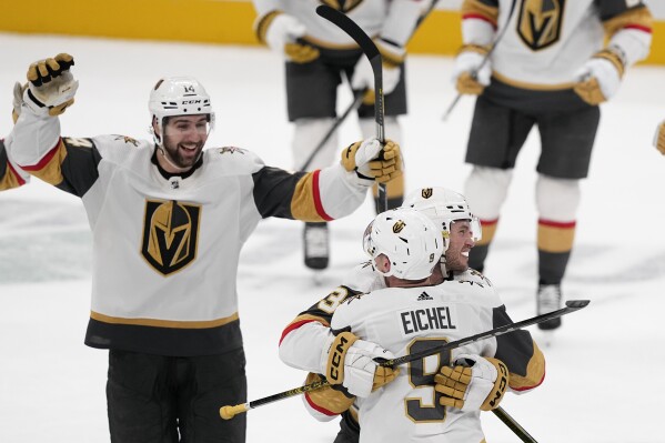 Vegas Golden Knights center Jack Eichel (9) celebrates with teammates his game-winning goal against the Dallas Stars during overtime of an NHL hockey game, Wednesday, Nov. 22, 2023, in Dallas. The Golden Knights won 2-1. (AP Photo/Tony Gutierrez)