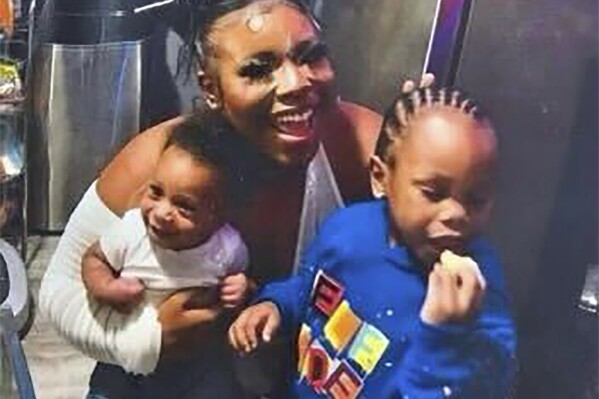 In this photo released by the Young Family via their family attorney, Ta'Kiya Young is pictured with her sons, Ja'Kobie, right, and Ja'Kenlie, left, in an undated photo. Young was shot and killed on Aug. 24, 2023, by Blendon Township police outside an Ohio supermarket. The 21-year-old was pregnant and due to give birth in November, according to her family. (Courtesy of Young Family/Walton + Brown LLP via AP)