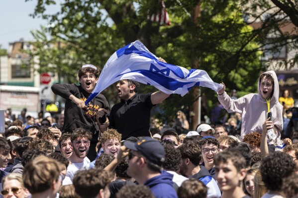 People gathered in Huyler Park celebrate the release of American hostage Edan Alexander from Hamas on Monday, May 12, 2025, in Tenafly, N.J. (AP Photo/Stefan Jeremiah)