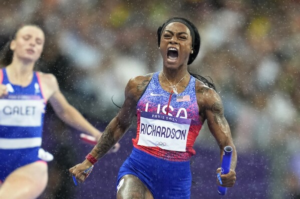 Sha'carri Richardson, of the United States, crosses the finish line to win the gold medal in the women's 4 x 100 meters relay final at the 2024 Summer Olympics, on Aug. 9, 2024, in Saint-Denis, France. (AP Photo/Ashley Landis, File)