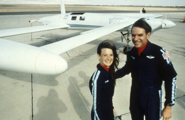FILE - Co-pilots Dick Rutan, right, and Jeana Yeager, no relationship to test pilot Chuck Yeager, pose for a photo after a test flight over the Mojave Desert, Dec. 19, 1985. Rutan, a decorated Vietnam War pilot, who along with copilot Yeager completed one of the greatest milestones in aviation history: the first round-the-world flight with no stops or refueling, died late Friday, May 3, 2024. He was 85. (AP Photo/Doug Pizac, File)