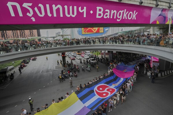 Participants hold a rainbow flag in the annual Pride Parade to celebrate the LGBTQ+ community’s Pride Month in Bangkok, Thailand, Sunday, June 1, 2025. (AP Photo/Sakchai Lalit)