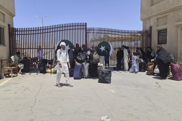 Pakistani families, who were stuck in Iran due to Israeli strikes on Iran, wait for clearance after entering in homeland through Taftan, a joint border crossing point on Pakistan Iran border, Wednesday, June 18, 2025. (AP Photo/Fateh Muhammad)