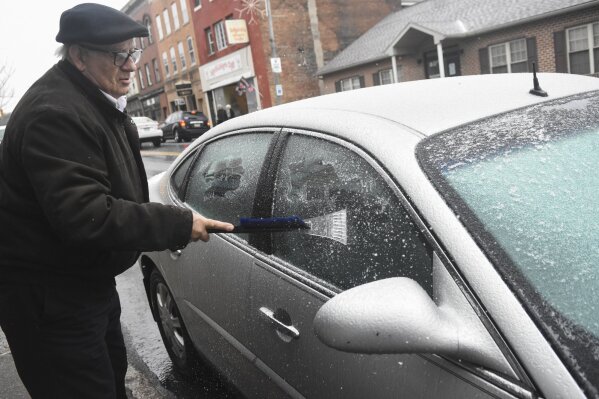 Paul Ciotti, of Minersville, Pa., scrapes ice off of his car windshield parked along Sunbury Street in Minersville, Pa., on Sunday, Dec. 1, 2019. (Jacqueline Dormer/Republican-Herald via AP)