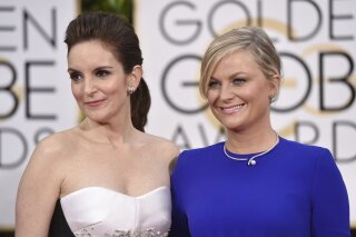 FILE - In this Jan. 11, 2015 file photo, Tina Fey, left, and Amy Poehler arrive for the 72nd annual Golden Globe Awards in Beverly Hills, Calif. On Saturday, Jan. 11, 2020, Poehler announced she an...