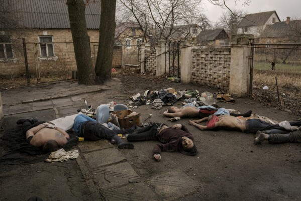Lifeless bodies of men, some with their hands tied behind their backs, lie on the ground in Bucha, Ukraine, Sunday, April 3, 2022. (AP Photo/ Vadim Ghirda)