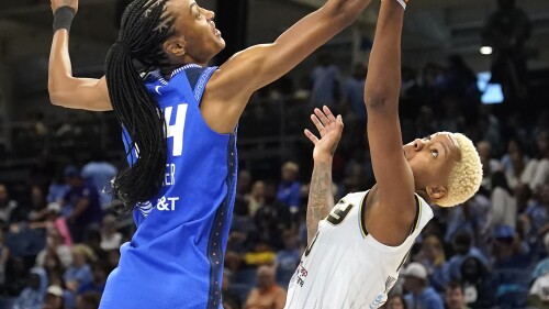 Connecticut Sun's DeWanna Bonner, left, and Chicago Sky's Courtney Williams battle for a rebound during the first half of a WNBA basketball game Wednesday, July 12, 2023, in Chicago. (AP Photo/Charles Rex Arbogast)