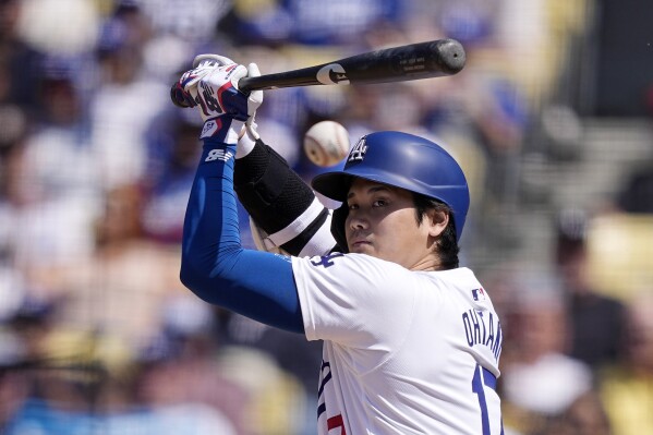 Los Angeles Dodgers' Shohei Ohtani hits a foul ball during the eighth inning of a baseball game against the Cincinnati Reds Sunday, May 19, 2024, in Los Angeles. (AP Photo/Mark J. Terrill)