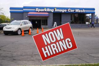 FILE - In this Sept. 2, 2020, file photo, a help wanted sign is displayed at a car wash in Indianapolis. Indiana’s Department of Workforce Development said Wednesday, July 7, 2021 that it still hasn’t decided how to continue payment of federal unemployment benefits more than a week after a judge ruled that the state must restart the extra $300 weekly payments to unemployed workers. (AP Photo/Michael Conroy, File)