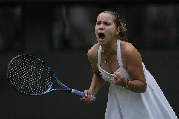 Sofia Kenin of the US celebrates winning a point from Coco Gauff of the US during the first round women's singles match on day one of the Wimbledon tennis championships in London, Monday, July 3, 2023. (AP Photo/Alastair Grant)