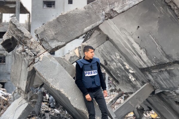 In this photo provided by Ramzy Abu al-Qumssan, he visits the rubble of his home in Gaza's Jabaliya refugee camp on Jan. 25, 2024, after it was hit in an Israeli airstrike Nov. 16, 2023. The strike killed his wife, daughter, mother, two sisters and 12 other relatives. (Courtesy Ramzy Abu al-Qumssan via AP)