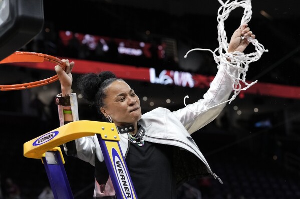 South Carolina head coach Dawn Staley cuts down the net after the Final Four college basketball championship game against Iowa in the women's NCAA Tournament, Sunday, April 7, 2024, in Cleveland. South Carolina won 87-75. (AP Photo/Morry Gash)