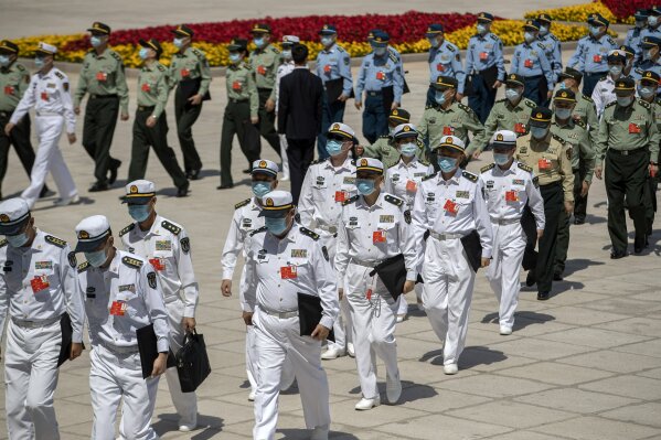 Military delegates arrive for the closing session of China's National People's Congress (NPC) at the Great Hall of the People in Beijing, Thursday, May 28, 2020. China’s legislature endorsed a national security law for Hong Kong on Thursday that has strained relations with the United States and Britain and prompted new protests in the territory. (AP Photo/Mark Schiefelbein)