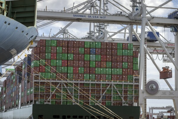 FILE - In this photo provided by the Georgia Ports Authority, a vessel is loaded with containers by a ship to shore crane at the Georgia Ports Authority's Port of Savannah Garden City Terminal, on Oct. 21, 2021, in Savannah, Ga. Georgia's seaports are reporting their second-busiest year despite a decline in the volume of retail goods moving across their docks. The Georgia Ports Authority said Tuesday, July 25, 2023, that the Port of Savannah handled 5.4 million container units of imports and exports in the 2023 fiscal year that ended June 30. (Stephen B. Morton/Georgia Port Authority via AP)