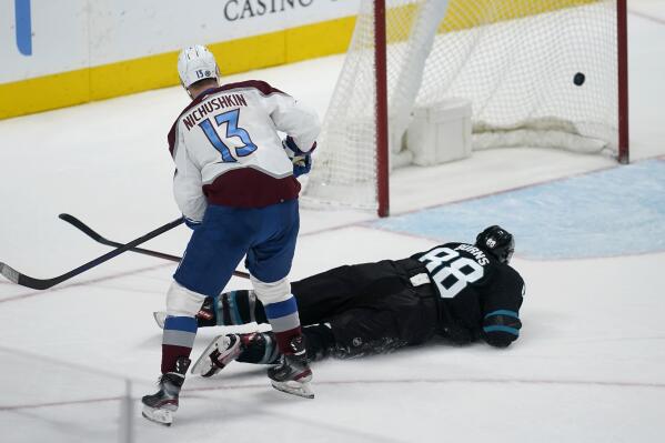 Colorado Avalanche right wing Valeri Nichushkin (13) watches his empty-net goal against San Jose Sharks defenseman Brent Burns (88) during the third period of an NHL hockey game in San Jose, Calif., Friday, March 18, 2022. (AP Photo/Jeff Chiu)