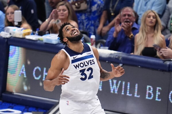 Minnesota Timberwolves center Karl-Anthony Towns (32) reacts to a play during the second half in Game 4 of the NBA basketball Western Conference finals against the Dallas Mavericks, Tuesday, May 28, 2024, in Dallas. (AP Photo/Julio Cortez)