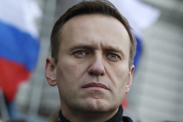 FILE - Russian opposition activist Alexei Navalny takes part in a march in memory of opposition leader Boris Nemtsov in Moscow, Russia on Feb. 29, 2020. Associates of imprisoned Russian opposition leader Alexei Navalny say he has been located at a prison colony above the Arctic Circle nearly three weeks after contact with him was lost. Navalny, the most prominent foe of Russian President Vladimir Putin, is serving a 19-year sentence on charges of extremism. (AP Photo/Pavel Golovkin, File)