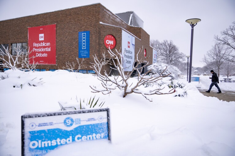 Signs are displayed ahead of the Republican presidential debate at Drake University in Des Moines, Iowa, Tuesday, Jan. 9, 2024. (AP Photo/Andrew Harnik)
