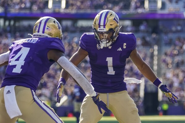 Washington wide receiver Rome Odunze (1) celebrates after his touchdown against Tulsa with teammate Germie Bernard (4) during the second half of an NCAA college football game Saturday, Sept. 9, 2023, in Seattle. (AP Photo/Lindsey Wasson)