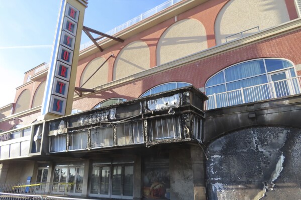 Scaffolding blocks off part of the Atlantic City, N.J. Boardwalk on Nov. 16, 2023, a day after a fire damaged part of the walkway and part of the facade of Resorts casino, which remained open. (AP Photo/Wayne Parry)