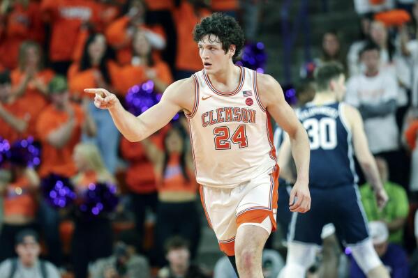 Clemson center PJ Hall (24) points to a teammate after receiving an assist during the first half of an NCAA college basketball game against Duke in Clemson, S.C., Saturday, Jan. 14, 2023. (AP Photo/Artie Walker Jr.)