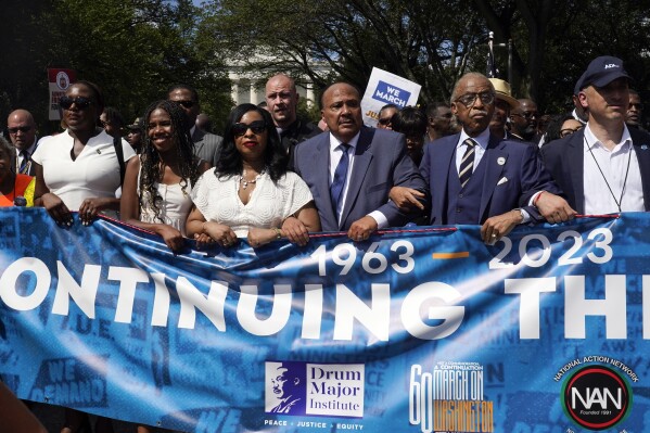 FILE - The Rev. Al Sharpton, second from right, joins Martin Luther King III, the son of Martin Luther King Jr., third from right, his wife Arndrea Waters King and their daughter Yolanda King as they march to honor the 60th Anniversary of the March on Washington, Saturday, Aug. 26, 2023, in Washington. (AP Photo/Jacquelyn Martin, File)